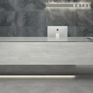 Concept - Hotel reception with grey concrete look on floor and counter, Pamesa