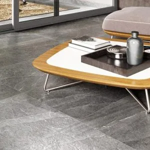 PIETRA DI LAVAGNA - Living room with dark stone look on the floor, Pamesa