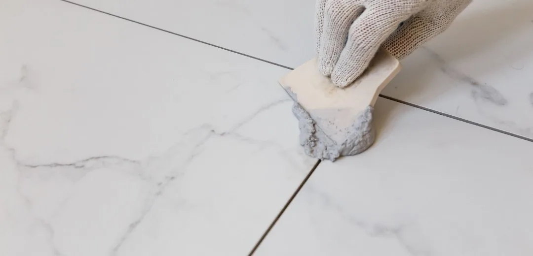 Tile joint thickness in cross-section with grout and adhesive layer on a project floor