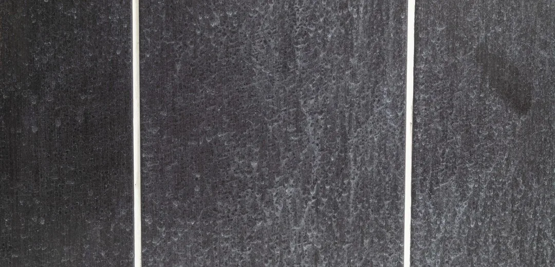 Removing limescale from a bathroom tile with cleaner and sponge